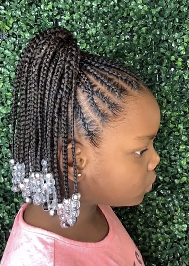 Child's braided ponytail with beads, styled at Victory Beauty.