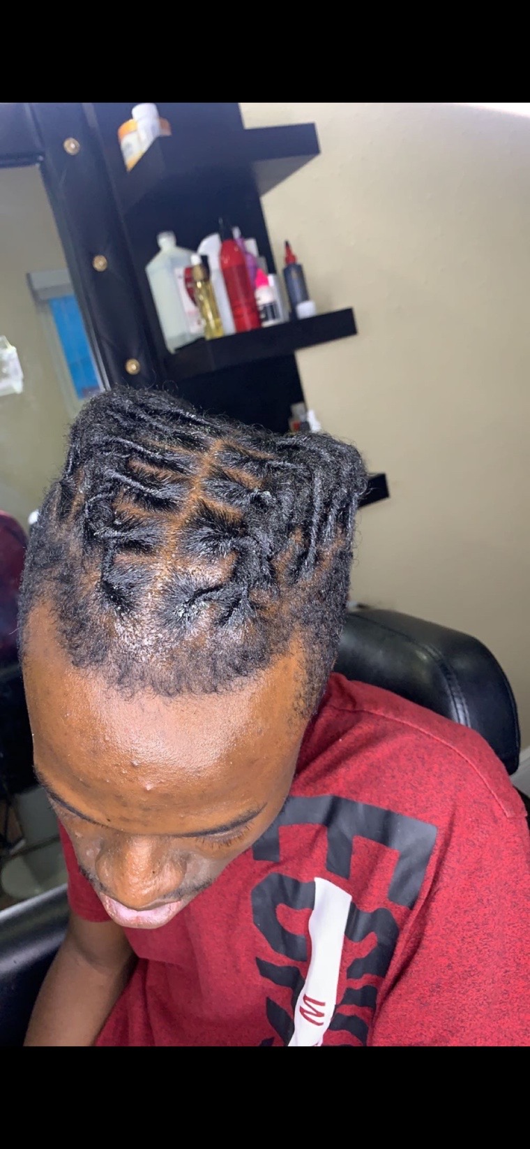 Retwisted locs styled into barrel curls.
