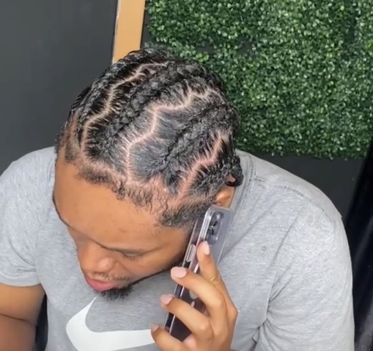 Men's cornrows braided back in a clean pattern.
